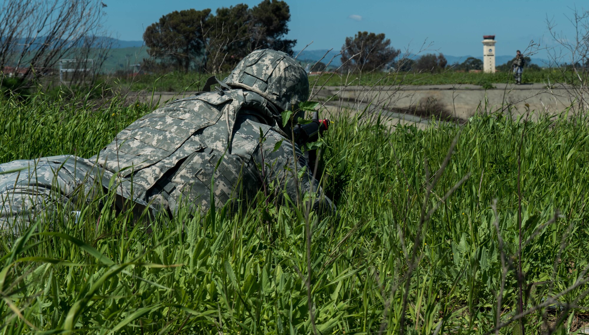 Staff Sgt. Julian Irvin, 921st Contingency Response Squadron lays in the prone position with his assault rifle pointing down range as a simulated threat approaches during field craft training April 1, 2016, at Travis Air Force Base, California. The five day training course was designed to improve how contingency response Airmen are trained in air base opening combat skills. (U.S. Air Force photo by Staff  Sgt. Robert  Hicks/Released)  