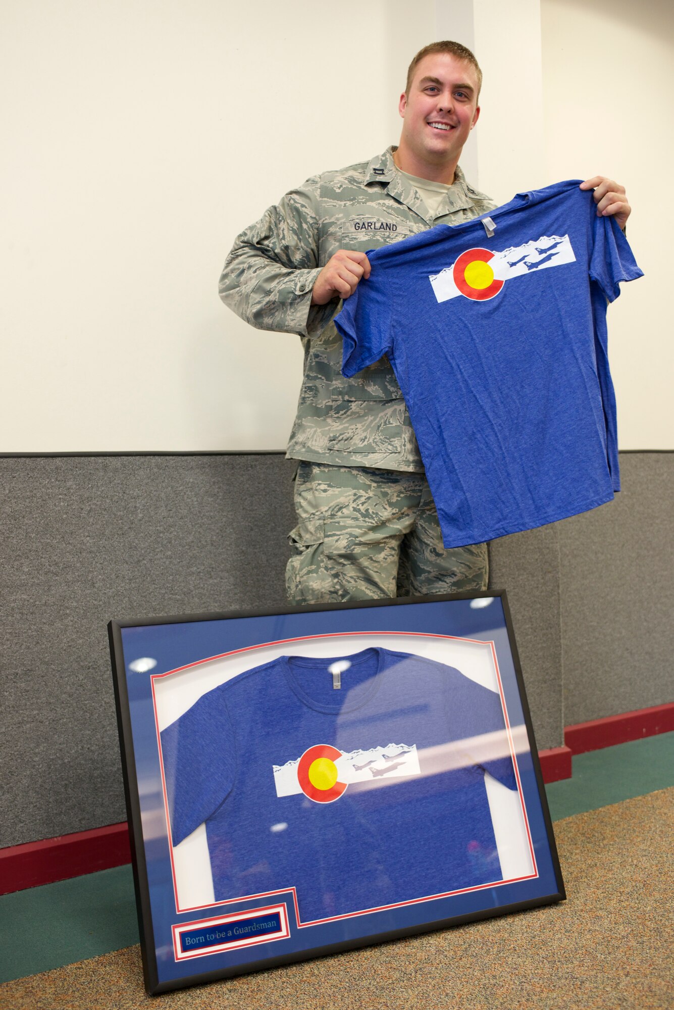 U.S. Air Force Capt. Benjamin N. Garland, Public Affairs Officer and offensive lineman for the Atlanta Falcons, assigned to 140th Wing, receives a token of thanks from the Army National Guard at Buckley Air Force Base Feb. 21, 2016. Garland designed a curriculum and trained service members, alongside Army National Guardsmen, about the importance of reporting concussions, military protocol and early treatment. (U.S. Air National Guard photo by Senior Airman Bobbie Reynolds)