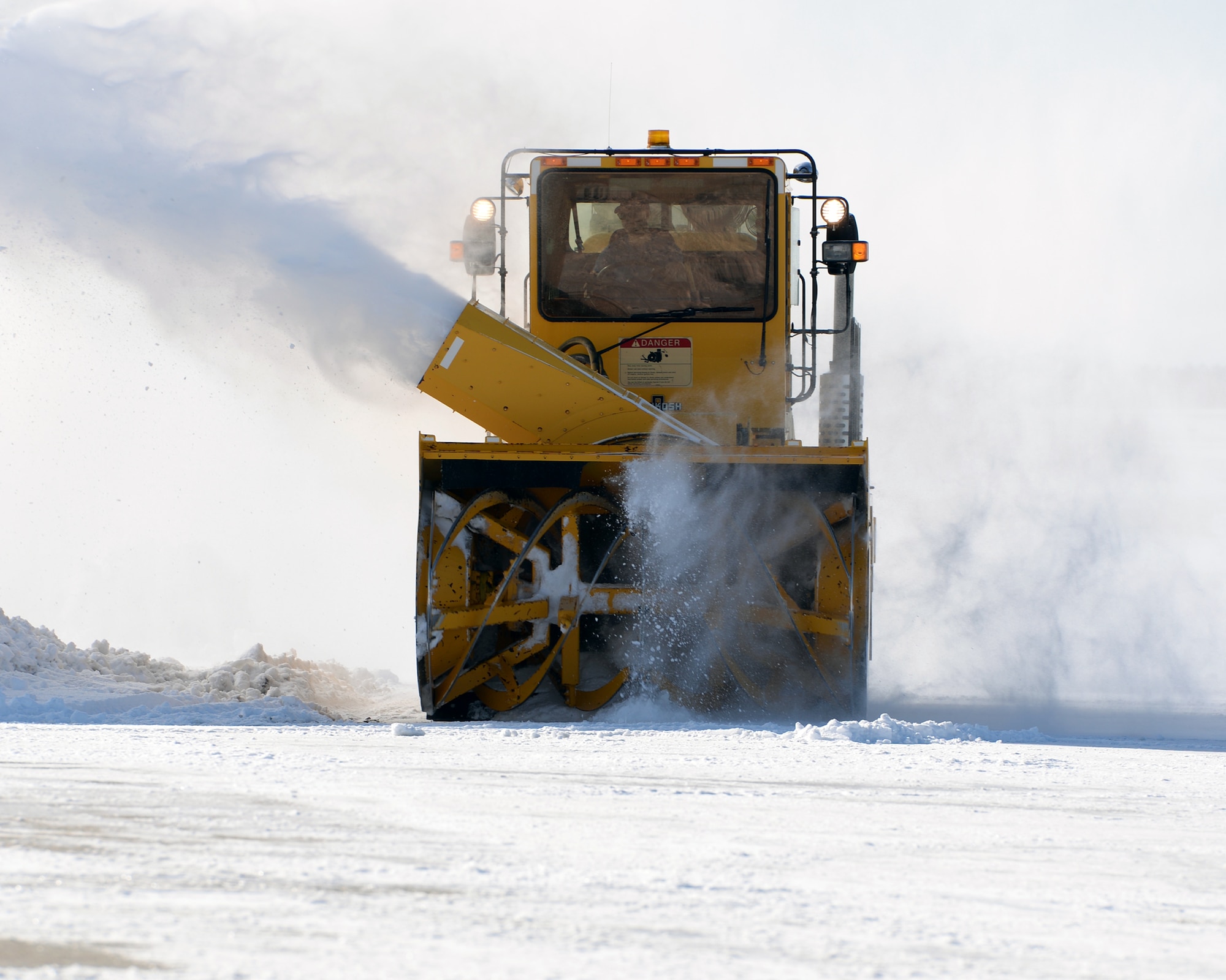 U.S. Air Force Tech. Sgt. Benjamin M. Kipp, from the 157th Civil Engineer Squadron, New Hampshire Air National Guard drives a blower to clear snow, Pease Air National Guard Base, N.H., April 5, 2016. (U.S. Air National Guard photo by Staff Sgt. Curtis J. Lenz)