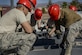Airmen, assigned to the 555th Red Horse Squadron, tighten bolts on structures that will become the roof of the new firehouse at Nellis Air Force Base, Nev., April 2, 2016. What make the 555th an invaluable asset to Nellis AFB are the relationships it shares with other squadrons on base, including the 820th RHS. (U.S. Air Force photo by Airman 1st Class Kevin Tanenbaum)