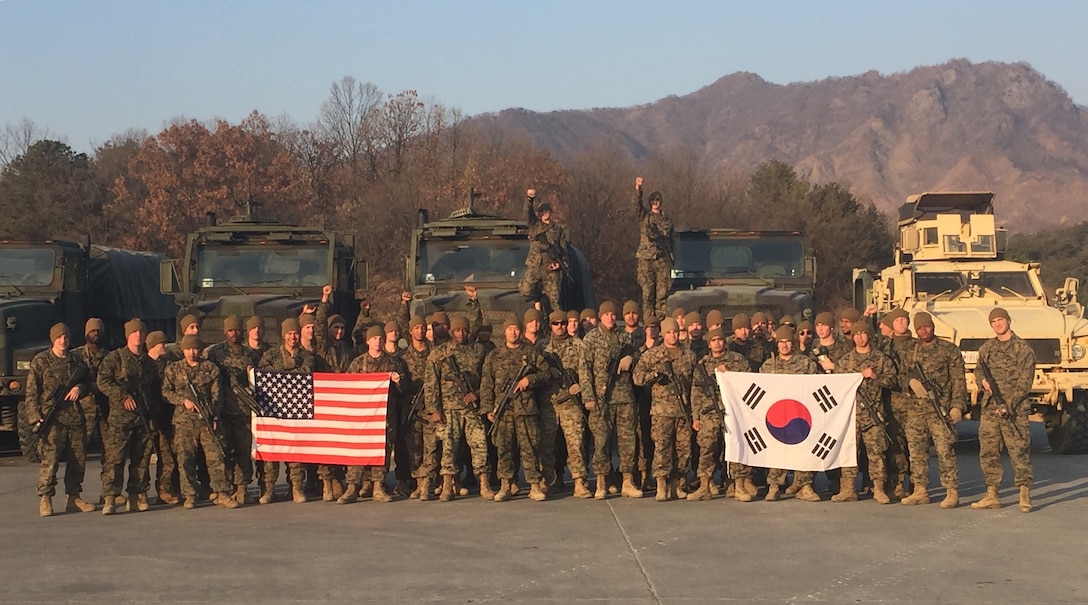 Marines from Motor Transport Platoon display the US and South Korean Flags Jan. 18, during their recent deployment to Rodriguez Life Fire Complex in the Republic of Korea. The Marines are from Combat Assault Battalion, 3rd Marine Division, III Marine Expeditionary Force, forward deployed in the Pacific.