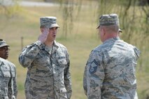 Staff Sgt. Jordan Hoyt, 51st Logistics Readiness Squadron fuels distribution supervisor, salutes Senior Master Sgt. Christopher Dobbertin, 51st LRS fuels superintendent, during the 30th anniversary fuel tank explosion ceremony at Osan Air Base, Republic of Korea. Hoyt saluted to signify one of the 16 individuals who passed away as a result of the explosion. (U.S. Air Force photo by Senior Airman Dillian Bamman/Released)