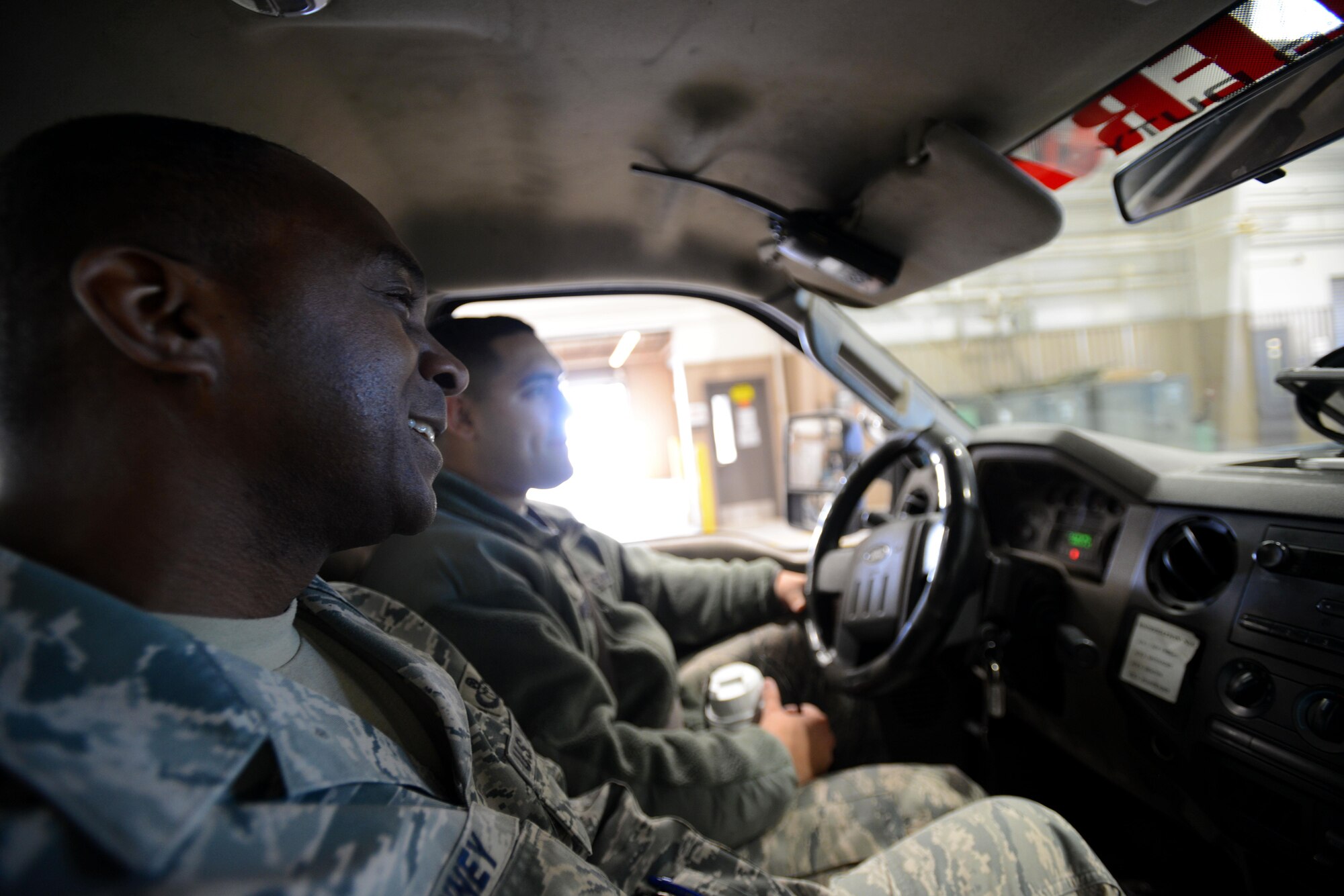 U.S. Air Force Senior Airman Corey Morales, 20th Equipment Maintenance Squadron aerospace ground equipment journeyman, and Chief Master Sgt. Christopher McKinney, 20th Fighter Wing command chief, take a ride down the flightline at Shaw Air Force Base, S.C., March 29, 2016. Morales showed McKinney the equipment that the AGE shop services, explaining the use and purpose of each. (U.S. Air Force photo by Airman 1st Class Kelsey Tucker)
