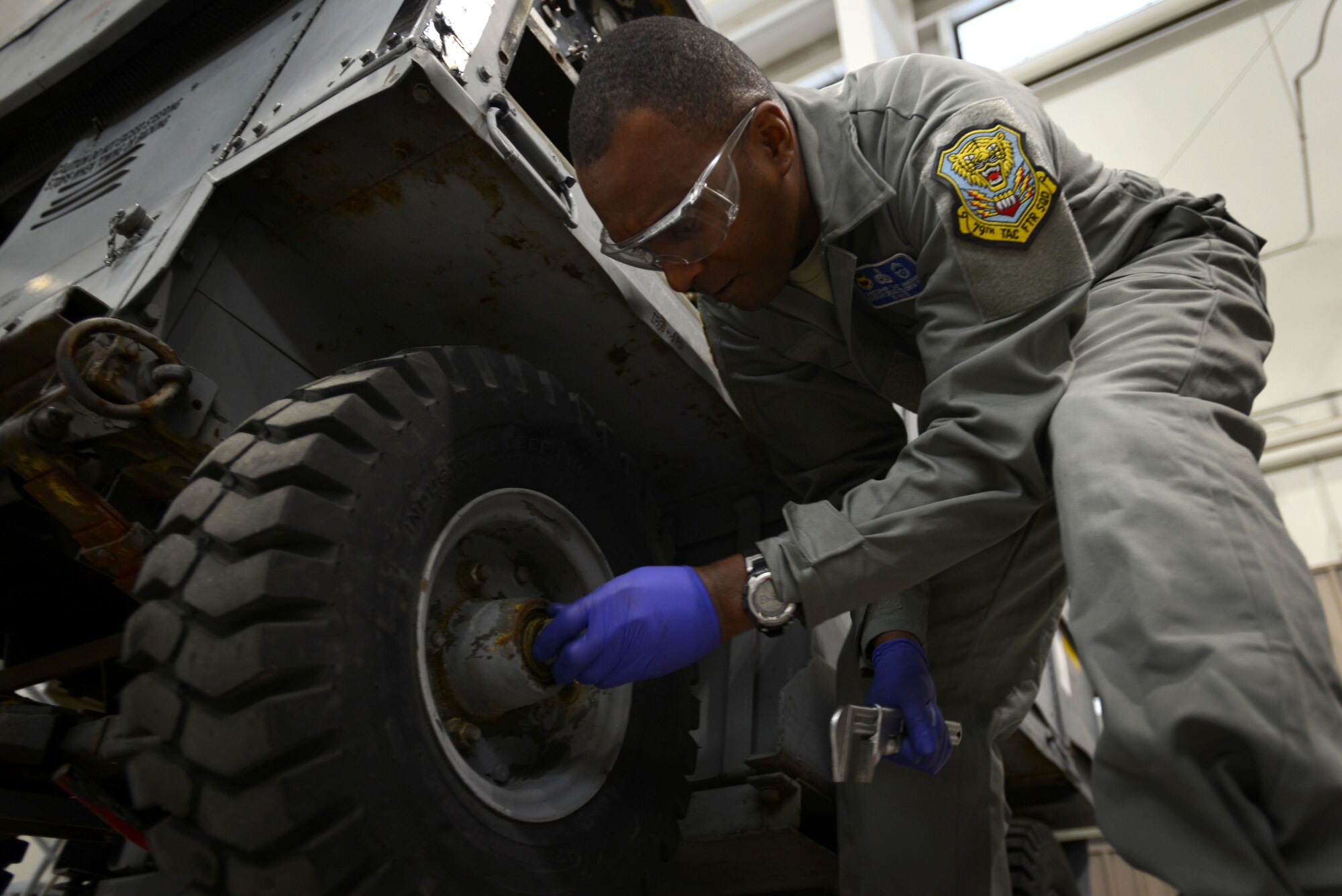 U.S. Air Force Chief Master Sgt. Christopher McKinney, 20th Fighter Wing command chief, checks the bearings of a tire on an A/M32A-60 generator in the 20th Equipment Maintenance Squadron aerospace ground equipment shop at Shaw Air Force Base, S.C., March 29, 2016. Cleaning and replacing the bearings was one of the tasks McKinney learned how to do while spending the morning with the AGE Airmen. (U.S. Air Force photo by Airman 1st Class Kelsey Tucker)