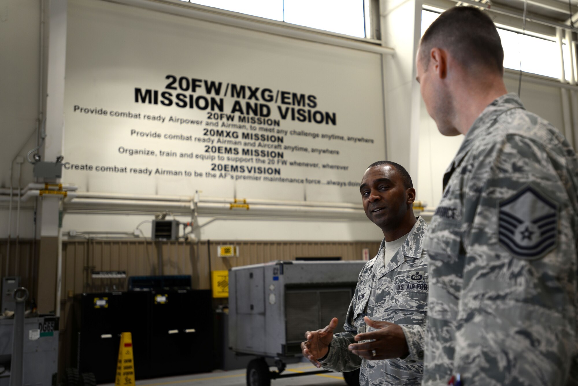 U.S. Air Force Chief Master Sgt. Christopher McKinney, 20th Fighter Wing command chief, speaks with Master Sgt. Jason Tilley, 20th Equipment Maintenance Squadron aerospace ground equipment flight chief, in the AGE shop at Shaw Air Force Base, S.C., March 29, 2016. McKinney spent the morning with AGE Airmen, learning about their job and how they contribute to keeping the 20th FW mission ready. (U.S. Air Force photo by Airman 1st Class Kelsey Tucker)