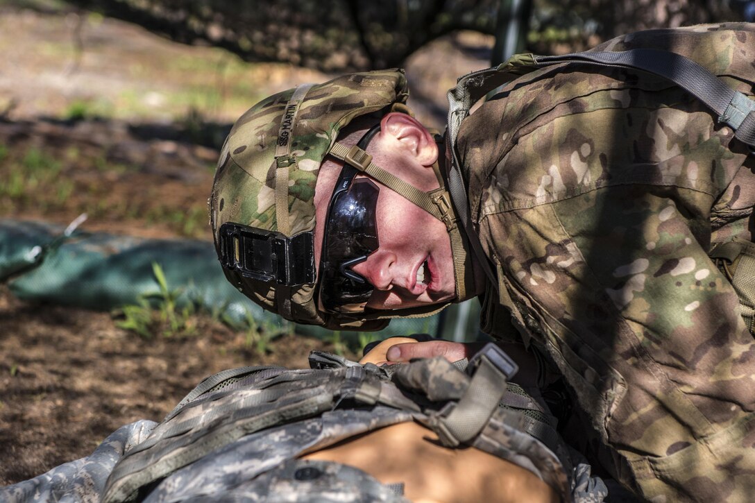 Army Staff Sgt. Jonathan Martin performs rescue breathing on a mannequin during the field medical testing part of the Expert Infantryman Badge qualification at Fort Jackson, S.C., March 30, 2016. Martin is a drill sergeant assigned to Company C, 1st Battalion, 61st Infantry Regiment. Army photo by Sgt. 1st Class Brian Hamilton