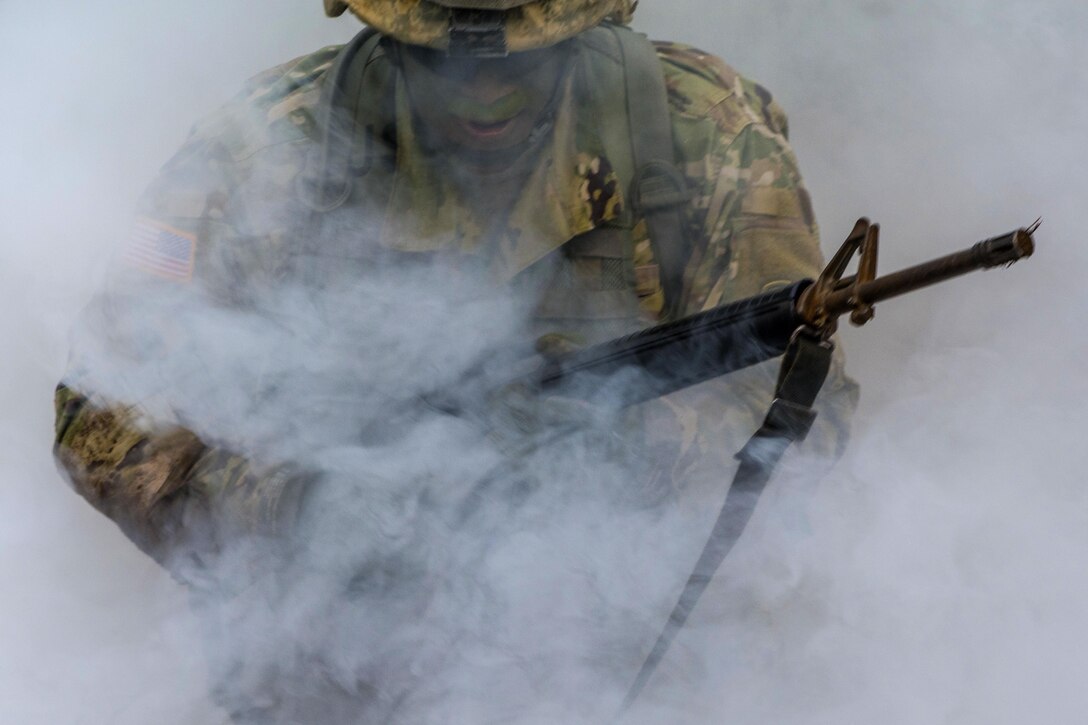 Army Staff Sgt. Tobias Henry advances through the cover of smoke while taking simulated direct fire during an Expert Infantryman Badge qualification at Fort Jackson, S.C., March 31, 2016. Henry is assigned to Special Troops Battalion, 171st Infantry Brigade. Army photo by Sgt. 1st Class Brian Hamilton