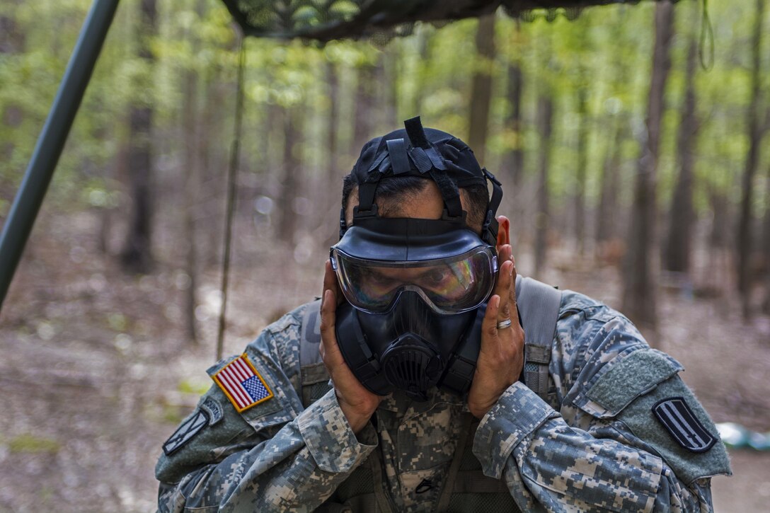 Army Staff Sgt. Juan Salgado checks the seal on his protective mask during an Expert Infantryman Badge qualification at Fort Jackson, S.C., March 31, 2016. Salgado is assigned to Company A, 3rd Battalion, 60th Infantry Regiment. Army photo by Sgt. 1st Class Brian Hamilton