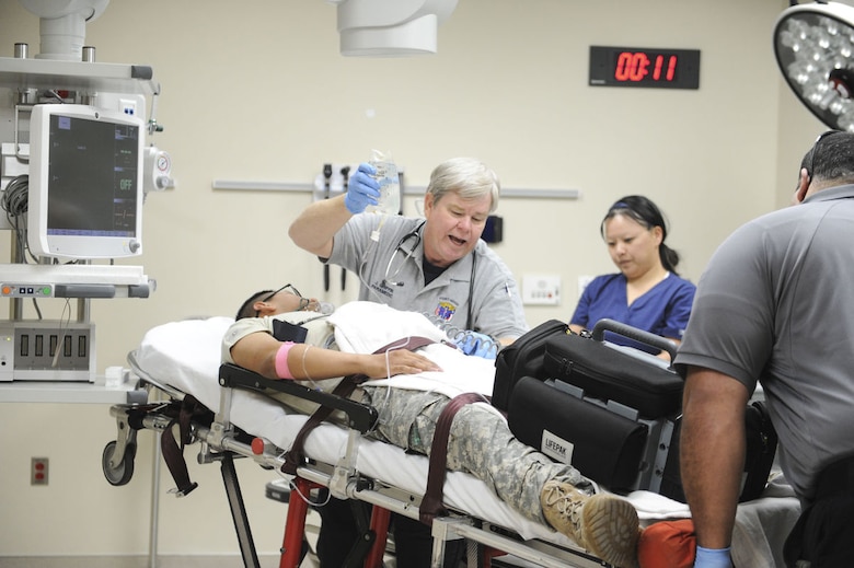 Paramedics and emergency department (ED) staff rush in a volunteer patient for a simulated trauma case during the Carl R. Darnall Army Medical Center "Day in the Life" event preparing the staff for the new hospital facility on Feb. 6. The ED moved into the new facility April 3.