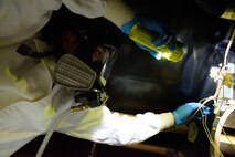 Senior Airman Sean Rotolo, 403rd Maintenance Squadron aircraft fuel system journeyman, assists with replacing an engine mount bolt inside the wing of a C-130J aircraft March 5, 2016, at Keesler Air Force Base, Mississippi. The bolt, which was near one of the plane’s fuel cells, had been cross threaded, so the engine was removed to facilitate replacing the bolt. Rotolo wore a full-face, supplied-air respirator to protect him from fuel fumes while inside the wing. (U.S. Air Force photo/Tech. Sgt. Ryan Labadens)