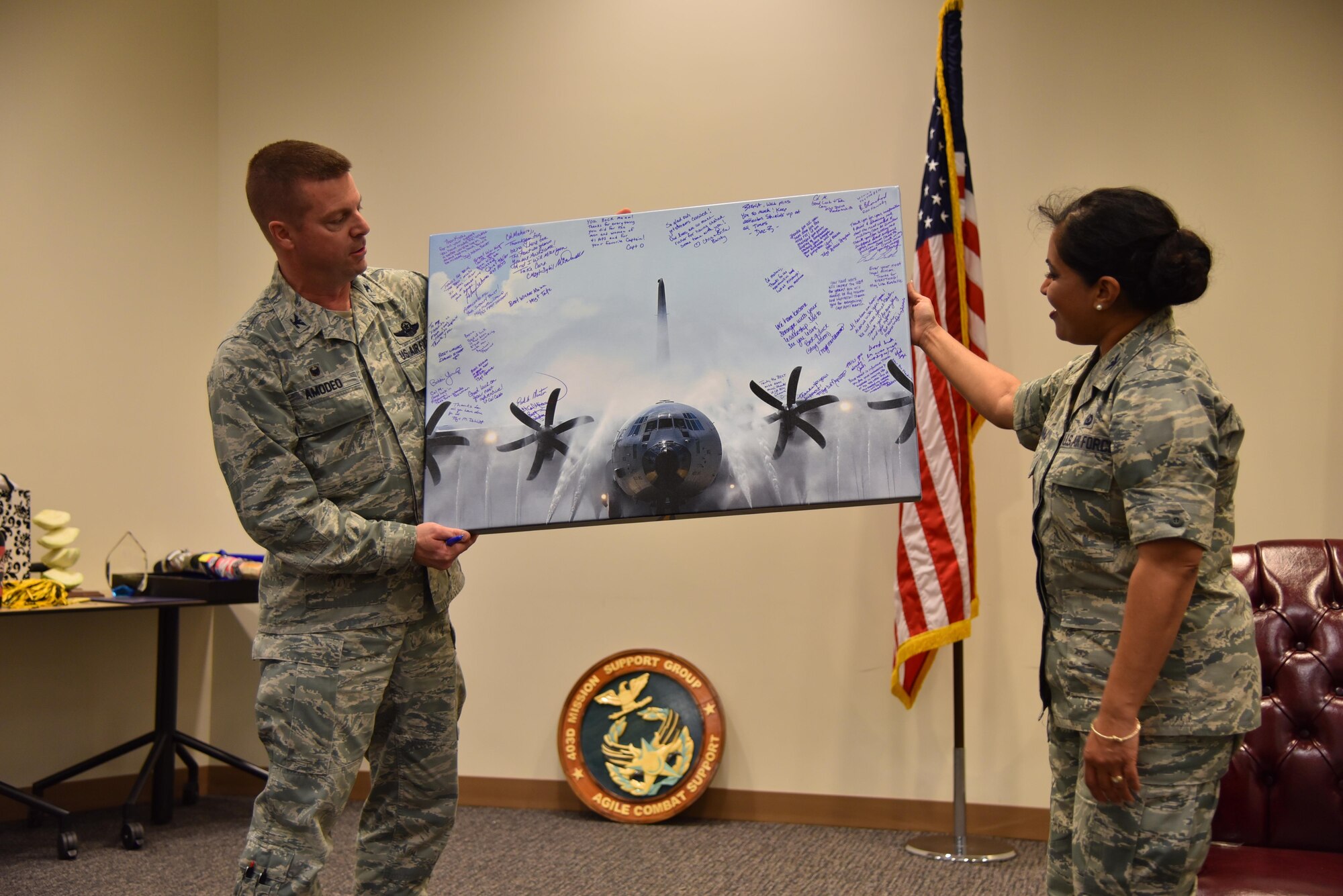 Col. Frank Amodeo, 403rd Wing commander, presents a signed photo to Col. Beena Maharaj, 403rd Mission Support Group commander, during a farewell event March 5, 2016, at Keesler Air Force Base, Mississippi. Maharaj is scheduled to take command of the 911th Mission Support Group at Pittsburgh International Airport Air Reserve Station, Pennsylvania (U.S. Air Force photo/Maj. Marnee Losurdo)
