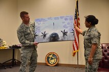 Col. Frank Amodeo, 403rd Wing commander, presents a signed photo to Col. Beena Maharaj, 403rd Mission Support Group commander, during a farewell event March 5, 2016, at Keesler Air Force Base, Mississippi. Maharaj is scheduled to take command of the 911th Mission Support Group at Pittsburgh International Airport Air Reserve Station, Pennsylvania (U.S. Air Force photo/Maj. Marnee Losurdo)
