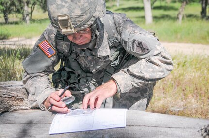 Staff Sgt. Jonathan Stamper, from 1st Training Brigade tests his land navigation skills at the U.S. Army Civil Affairs and Psychological Operations Command Best Warrior Competition at Fort Hunter Liggett, Cali., April 4, 2016. This year’s Best Warrior competition will determine the top noncommissioned officer and junior enlisted Soldier who will represent USACAPOC in the Army Reserve Best Warrior competition later this year. (U.S. Army photo by Spc. Khadijah Lutz-Wilcox, USACAPOC)