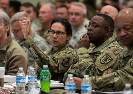 Maj. Gen. Phillip Churn (right), commanding general of the 200th Military Police Command, and Brig. Gen. Marion Garcia, deputy commanding general (operations), discuss information posted on a screen during a four-day workshop and Yearly Training Brief conference held by the 200th MP Cmd. in Columbus, Ohio, on April 2. During the event, battalion and brigade leaders worked to improve their readiness and briefed the commanding general and his command leadership on their units' status. (U.S. Army photo by Master Sgt. Michel Sauret)