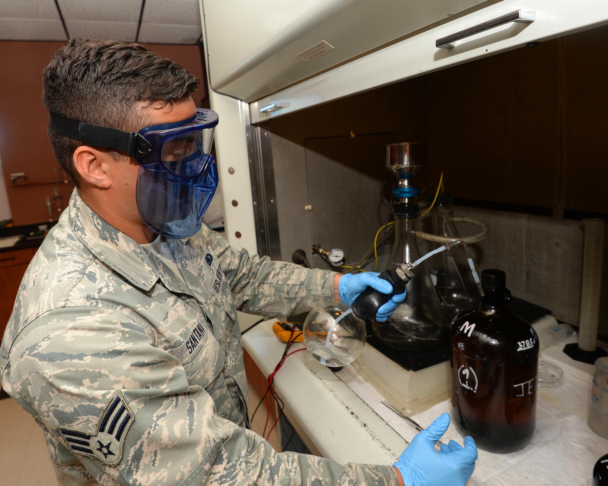 Senior Airman Omar Santana, 325th Logistics Readiness Squadron fuels laboratory technician, performs a particulate matter test on a fuels sample at Tyndall Air Force Base, April 5.  The testing lab at the Fuels Management Flight performs constant testing of the quality of fuel that is shipped to Tyndall. This ensures the F-22 Raptor gets the highest quality of fuel to keep it projecting air combat superiority. (U.S. Air Force photo by Airman 1st Class Cody R. Miller/Released)