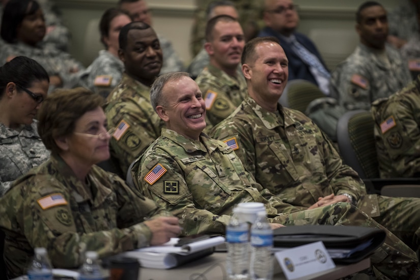 Brig. Gen. Phillip Jolly and Sgt. Maj. Mike Schultz, both with the Army Reserve Engagement Cell (AREC), U.S. Army Europe, Germany, share a laugh as a fellow AREC member from U.S. Army North takes the stage to brief the 200th Military Police Command headquarters leadership during a four-day workshop and Yearly Training Brief conference held in Columbus, Ohio, on April 2. AREC members from various Army Service Component Commands attended this YTB in order to grow partnerships between the 200th MP Cmd. and Army component commands across the globe. (U.S. Army photo by Master Sgt. Michel Sauret)