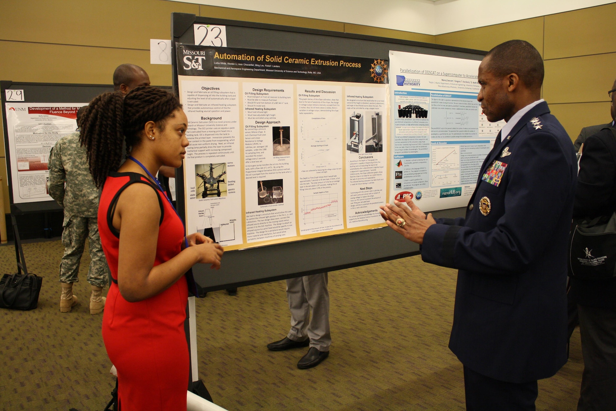 Gen. Darren McDew, the U.S. Transportation Command commander, speaks with a student about her engineering project at the 42nd annual convention of the National Society of Black Engineers on March 25, 2016, at the Boston Convention and Exhibition Center. The combatant command commander spoke with several groups while at the convention, as well as speaking with individual students about their efforts and ambitions. (Courtesy photo)