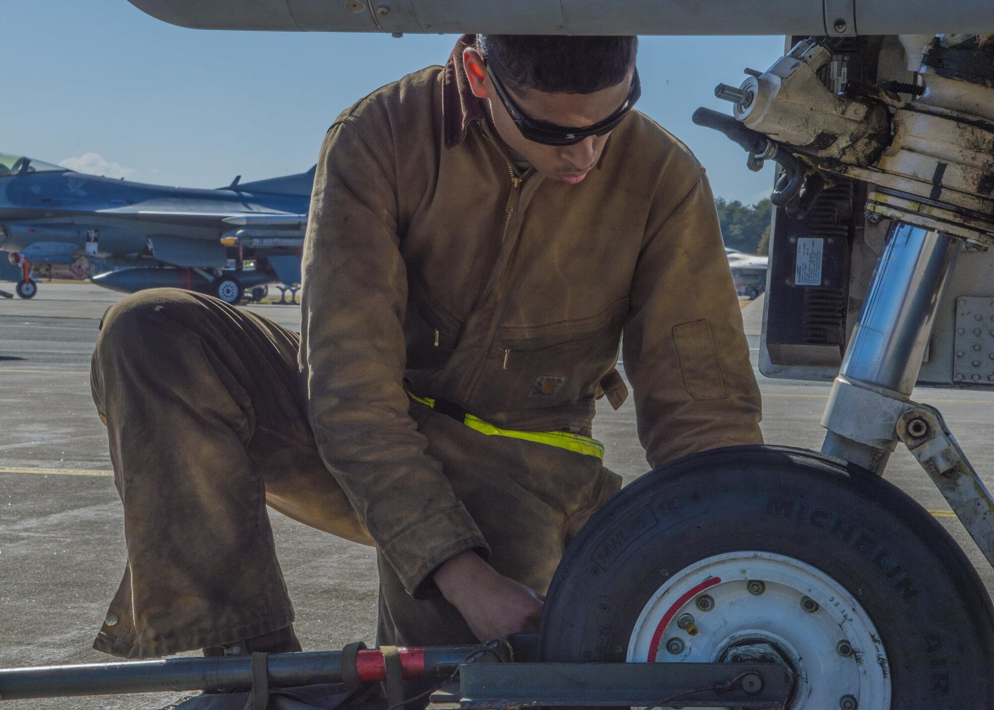 Senior Airman Kyle Lacy, a crew chief with the 35th Maintenance Squadron, performs a post-flight inspection on an F-16 Fighting Falcon during a surge exercise at Misawa Air Base, Japan, April 5, 2016. After aircraft land and return to their assigned crew chief, a post-flight inspection is conducted to ensure the aircraft didn’t accrue damage. During the two-day operation, the amount of time allotted for these inspections is decreased which heightens the tempo and simulates a combat environment. (U.S. Air Force photo/Airman 1st Class Jordyn Fetter)