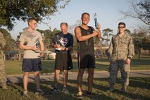 Winners of the 403rd Human Resources Development Council Spring Fever Chase 5k awarded trophies on March 5, 2016, at Keesler Air Force Base, Mississippi. The first place winner was Staff Sgt. Eric Sajowitz, 403rd Force Support Squadron, the second place winner was Maj. Andrew Belcher, 403rd Aeromedical Staging Squadron, and the third place winner was Senior Airman Ethan Schneider, 403rd Maintenance Squadron. (U.S. Air Force photo/Senior Airman Shelton Sherrill) 