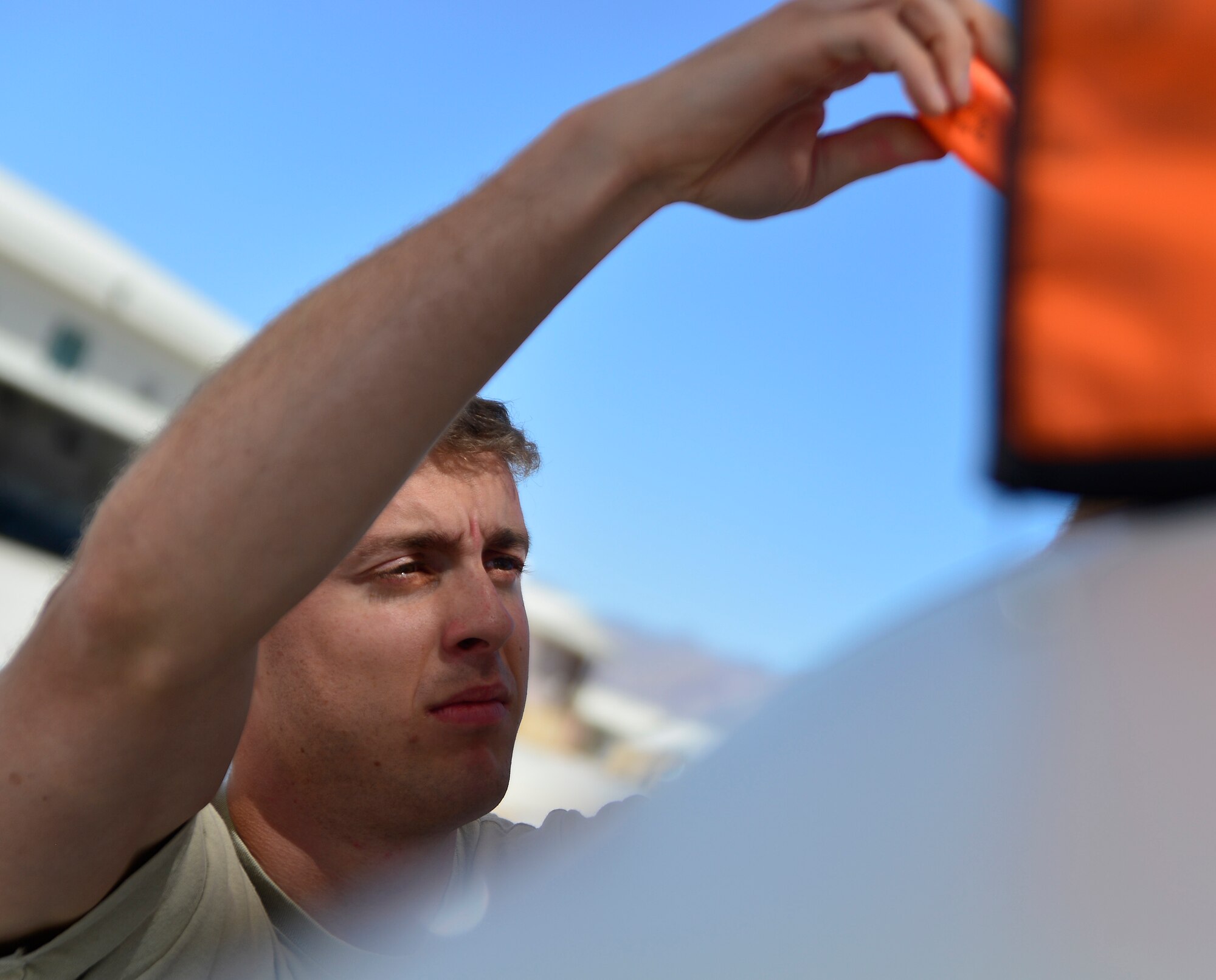 Staff Sgt. Ken, 432nd Aircraft Maintenance Squadron MQ-1 Predator crew chief, inspects an engine panel during a post-flight check April 5, 2015 at Creech Air Force Base, Nevada. During a post-flight check, crew chiefs complete scheduled maintenance and refuel the aircraft for the next mission. (U.S. Air Force photo by Senior Airman Christian Clausen/Released)