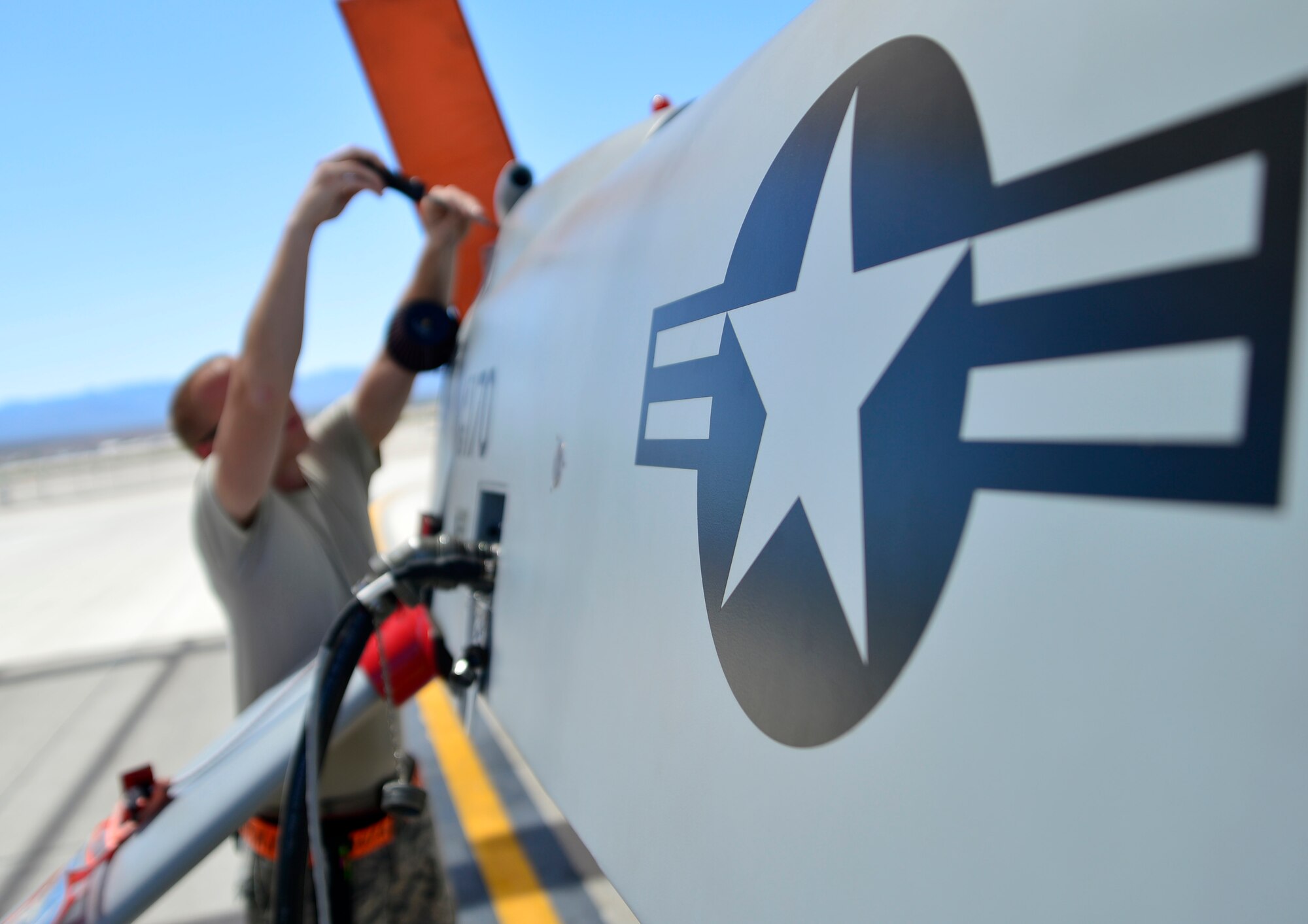 Senior Airman Jonathan, 432nd Aircraft Maintenance Squadron crew chief, take off an engine panel during a post-flight check April 5, 2015. Crew chiefs are responsible for supervising, monitoring, and directing aircraft maintenance. (U.S. Air Force photo by Senior Airman Christian Clausen/Released)