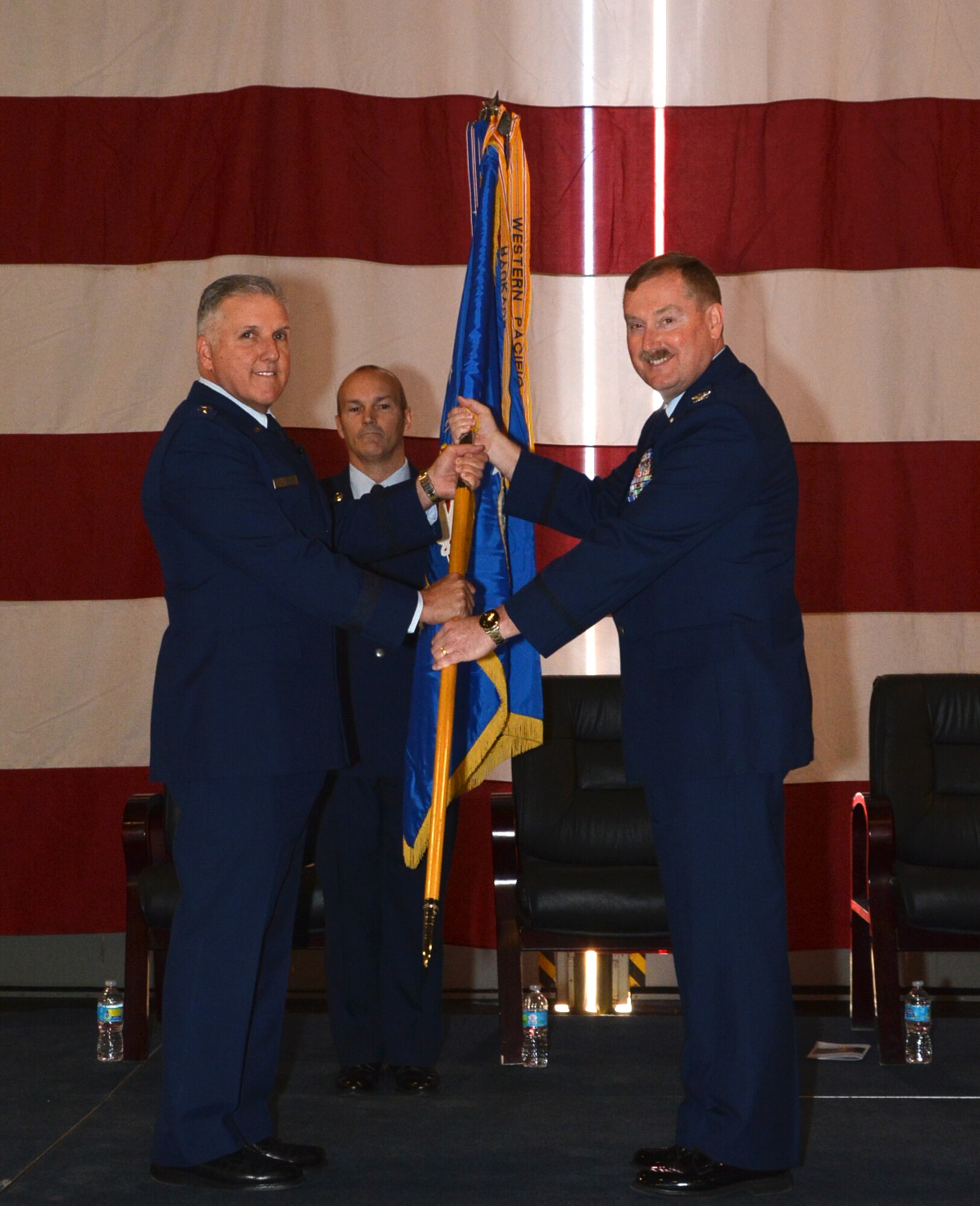 Maj. Gen. John C. Flournoy, Jr., Commander, Fourth Air Force, passes the guidon to the new 507th Air Refueling Wing commander, Col. Douglas E. Gullion, at the change of command ceremony April 2, 2016, at Tinker Air Force Base, Okla. Gullion is a command pilot who has served nearly 30 years and has flown more than 6,500 flight hours. (U.S. Air Force photo/Tech. Sgt. Lauren Gleason)