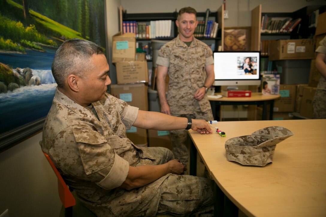 Lt. Col. Frank Marilao, assistant chief of staff, Marine Corps Community Services, completes a circuit using Little Bits (electronic circuits), during a STEM lab presentation at the Combat Center Library, March 22, 2016. (Official Marine Corps photo by Cpl. Connor Hancock/Released)