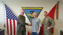 Marine Corps Air Station Camp Pendleton, Calif. -- Col. Ian R. Clark, left, Commanding Officer, and Lt. Col. David Fairleigh, right, Executive Officer of MCAS Camp Pendleton, congratulate Mr. Robert C. McCoy, center, Assistant Air Traffic Control Facility Officer in the ATC Facility, MCAS Camp Pendleton, on being awarded the 2015 Marine Corps Installation Command Senior General Schedule Category Employee of the Year, March 11, 2016.