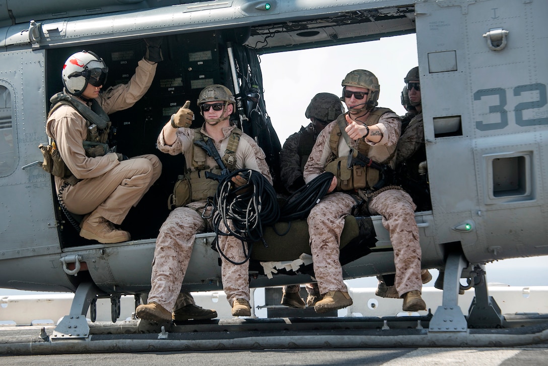 Marines give the thumbs up from a UH-1 helicopter as they prepare for rappel training aboard the USS Boxer in the Pacific Ocean, April, 1, 2016. Marine Corps photo by Sgt. Briauna Birl