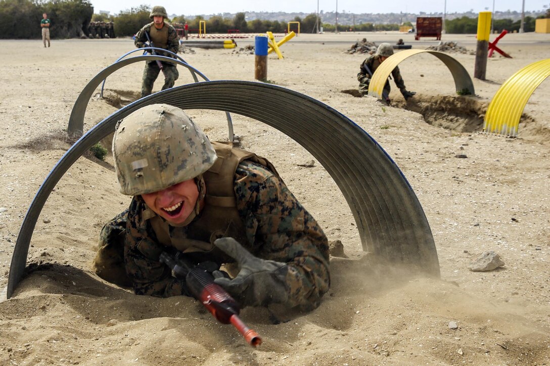 A Marine Corps recruit crawls through a tunnel as part of a bayonet assault course at Marine Corps Recruit Depot San Diego, March 29, 2016. The recruit is assigned to Alpha Company, 1st Recruit Training Battalion. Marine Corps photo by Lance Cpl. Angelica I. Annastas