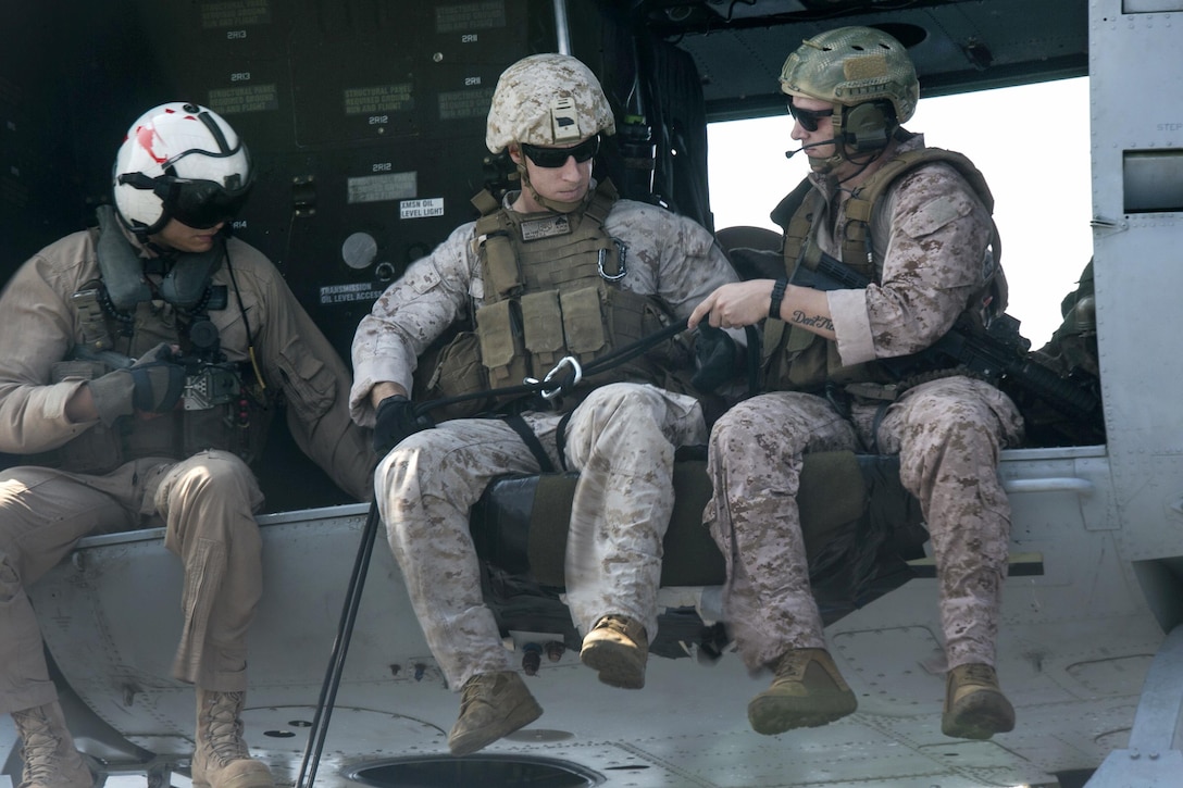 Marines prepare to rappel from a UH-1 helicopter aboard the USS Boxer in the Pacific Ocean, April 1, 2016. Marine Corps photo by Sgt. Briauna Birl