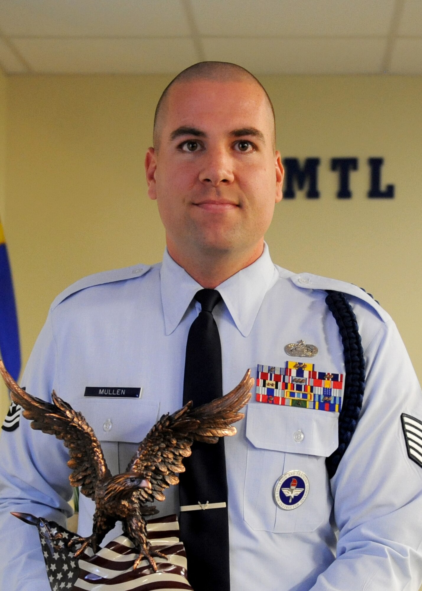 Tech. Sgt. Kyle Mullen, 81st Training Support Squadron military training leader course instructor, holds a 2nd Air Force annual award trophy at Allee Hall April 4, 2016, Keesler Air Force Base, Miss. Leadership from 2nd AF and the 81st Training Wing traveled to Mullen’s classroom to congratulate him on his accomplishments. (U.S. Air Force photo by Kemberly Groue)