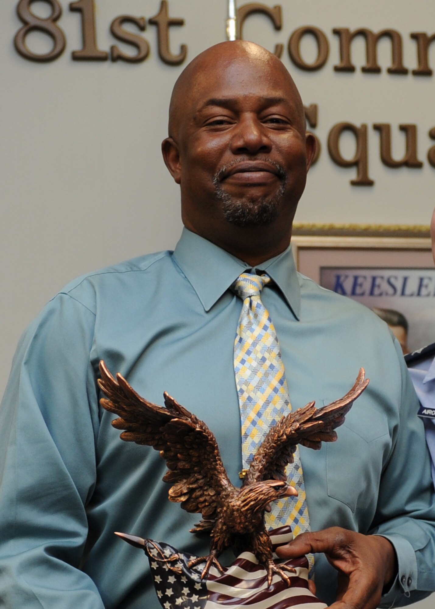 John Cobb, 81st Communications Squadron cyber service center chief, holds a 2nd Air Force annual award trophy at the 81st CS building April 4, 2016, Keesler Air Force Base, Miss. Leadership from 2nd AF and the 81st Training Wing traveled to Cobb’s work area to congratulate on his accomplishments. (U.S. Air Force photo by Kemberly Groue)