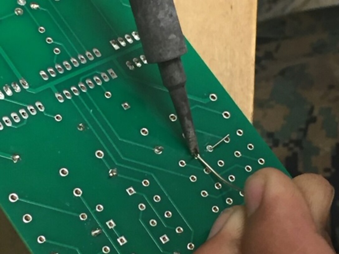 A Marine attached to Basic Engineer Equipment Electrical Systems Technician course 4-16 (BEEEST 4-16) uses the soldering method to repair a circuit card as part of his Military Occupational Specialty (MOS) training aboard Marine Corps Engineer School, Camp Lejeune, N.C.