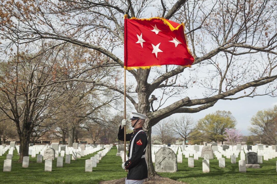 A U.S. Marine with Marine Barracks Washington, D.C. carries the general officer’s flag through Arlington National Cemetery during a funeral for retired Gen. Earl E. Anderson, former assistant commandant of the Marine Corps, Arlington, Va., March 31, 2016. Anderson was the first active duty Marine Naval Aviator to be promoted to a four-star rank, and he became the assistant commandant of the Marine Corps on April 1, 1972. (U.S. Marine Corps photo by Cpl. Samantha K. Draughon/Released)