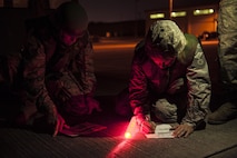 U.S. Air Force Airmen from the 18th Civil Engineer Squadron conduct nighttime airfield damage repair training at the Silver Flag training site April 5, 2016, on Kadena Air Base, Japan. The 18th CES plays an integral role as a fast response repair force by reestablishing damaged runways in order to maintain aircraft combat and logistical capabilities. (U.S. Air Force photo by Senior Airman Peter Reft/Released)