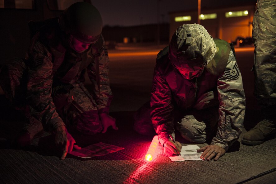 U.S. Air Force Airmen from the 18th Civil Engineer Squadron conduct nighttime airfield damage repair training at the Silver Flag training site April 5, 2016, on Kadena Air Base, Japan. The 18th CES plays an integral role as a fast response repair force by reestablishing damaged runways in order to maintain aircraft combat and logistical capabilities. (U.S. Air Force photo by Senior Airman Peter Reft/Released)