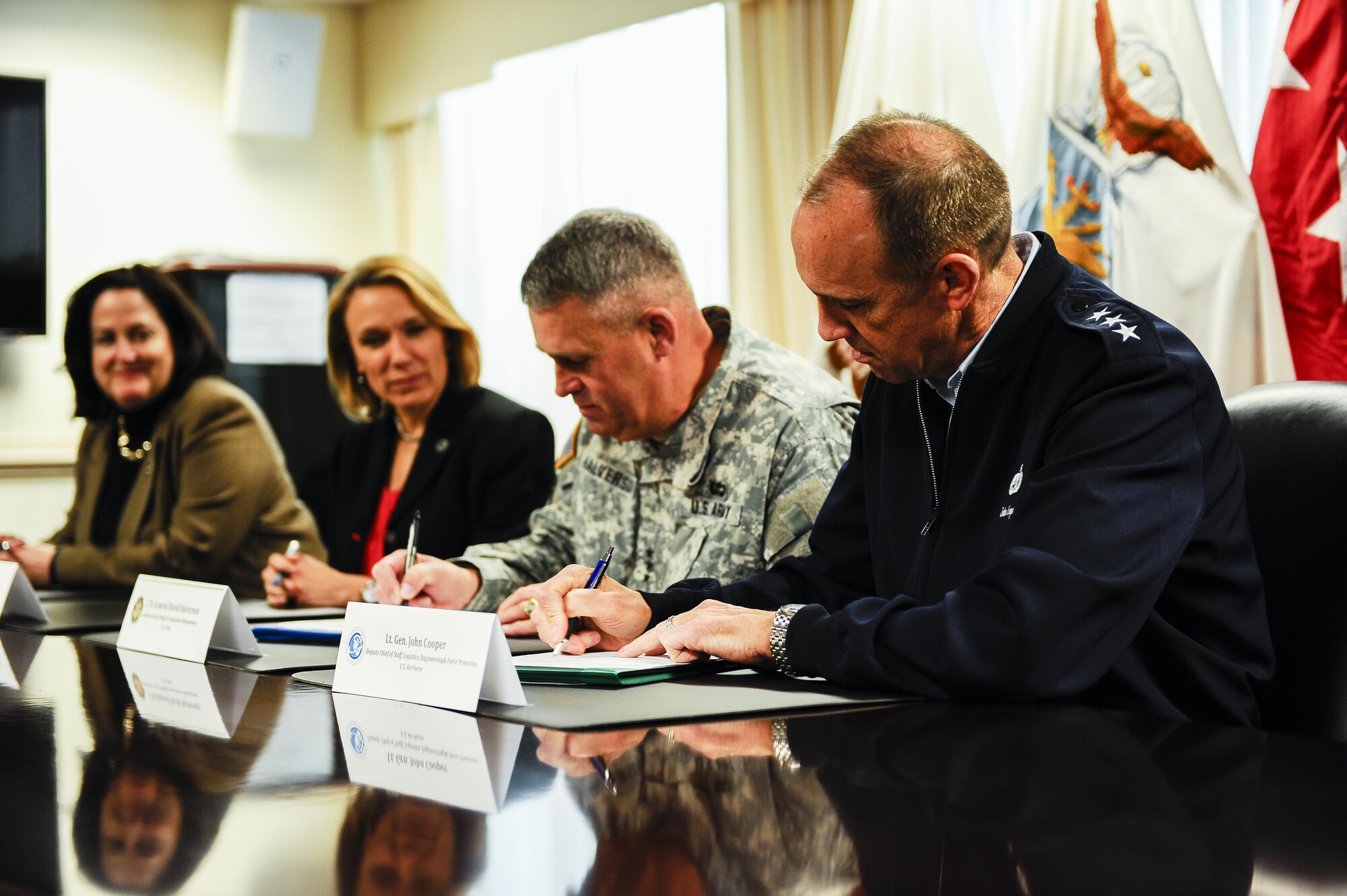 From front to back, Lt. Gen. John Cooper, the Air Force deputy chief of staff for logistics, engineering and force protection; Lt. Gen. David Halverson, the Army assistant chief of staff for installation management; Miranda Ballentine, the assistant secretary of the Air Force for installations, environment and energy; and Katherine Hammock, the assistant secretary of the Army for installations, energy and environment sign a memorandum of agreement that formalizes the partnership between the services’ energy offices at the Pentagon, Washington, D.C., April 6, 2016. (U.S. Air Force photo/Tech. Sgt. Bryan Franks)