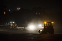U.S. Air Force Airmen from the18th Civil Engineer Squadron conduct a nighttime airfield damage repair contingency exercise at the Silver Flag training site April 5, 2016, on Kadena Air Base, Japan. Civil engineer Airmen demonstrated their capability to reestablish a damaged runway despite operating in a hostile environment and sustaining casualties from attacks. (U.S. Air Force photo by Senior Airman Peter Reft/Released)