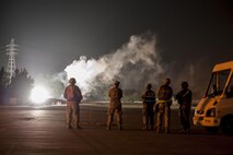 Wing Inspection Team members observe a simulated attack during a training exercise with the 18th Civil Engineer Squadron at the Silver Flag training site April 5, 2016, on Kadena Air Base, Japan. The 18th CES tested their ability to conduct airfield damage repair and maintain continuous airfield operations amidst a simulated air attack. (U.S. Air Force photo by Senior Airman Peter Reft/Released)