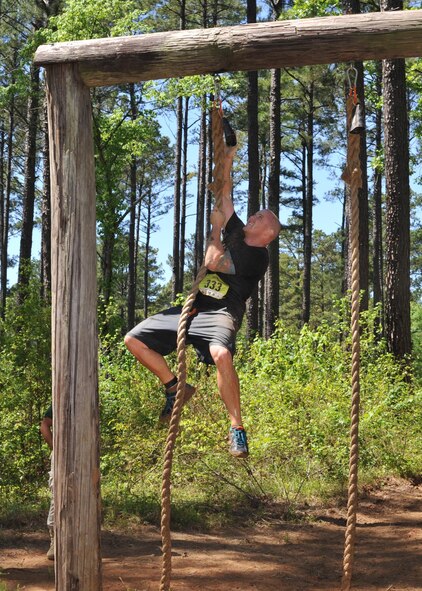 A 2016 Defenders of Liberty Mud Run participant rings a bell after climbing a 15-foot rope at Barksdale Air Force Base, La., April 2. This year’s course featured 20 obstacles designed to test the physical and mental limits of participants, and included wooden structures, multiple rope climbs and mud pits. (U.S. Air Force photo/Senior Airman Joseph Raatz)