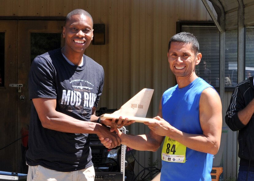 Randall Kingfisher, 2016 Defenders of Liberty Mud Run top male finisher, poses with Col. Brandon Parker, 2nd Bomb Wing vice commander, at Barksdale Air Force Base, La., April 2. Kingfisher finished the 4-mile race with a time of 34:20. (U.S. Air Force photo/Senior Airman Joseph Raatz)