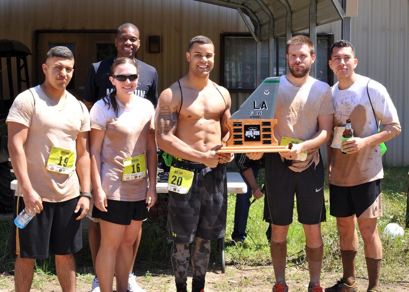The 2nd Security Forces Squadron 2016 Defenders of Liberty Mud Run team holds their trophy for fastest team at Barksdale Air Force Base, La., April 2. The five-person team finished the 4-mile race with a combined time of 4:16:51. (U.S. Air Force photo/Senior Airman Joseph Raatz)