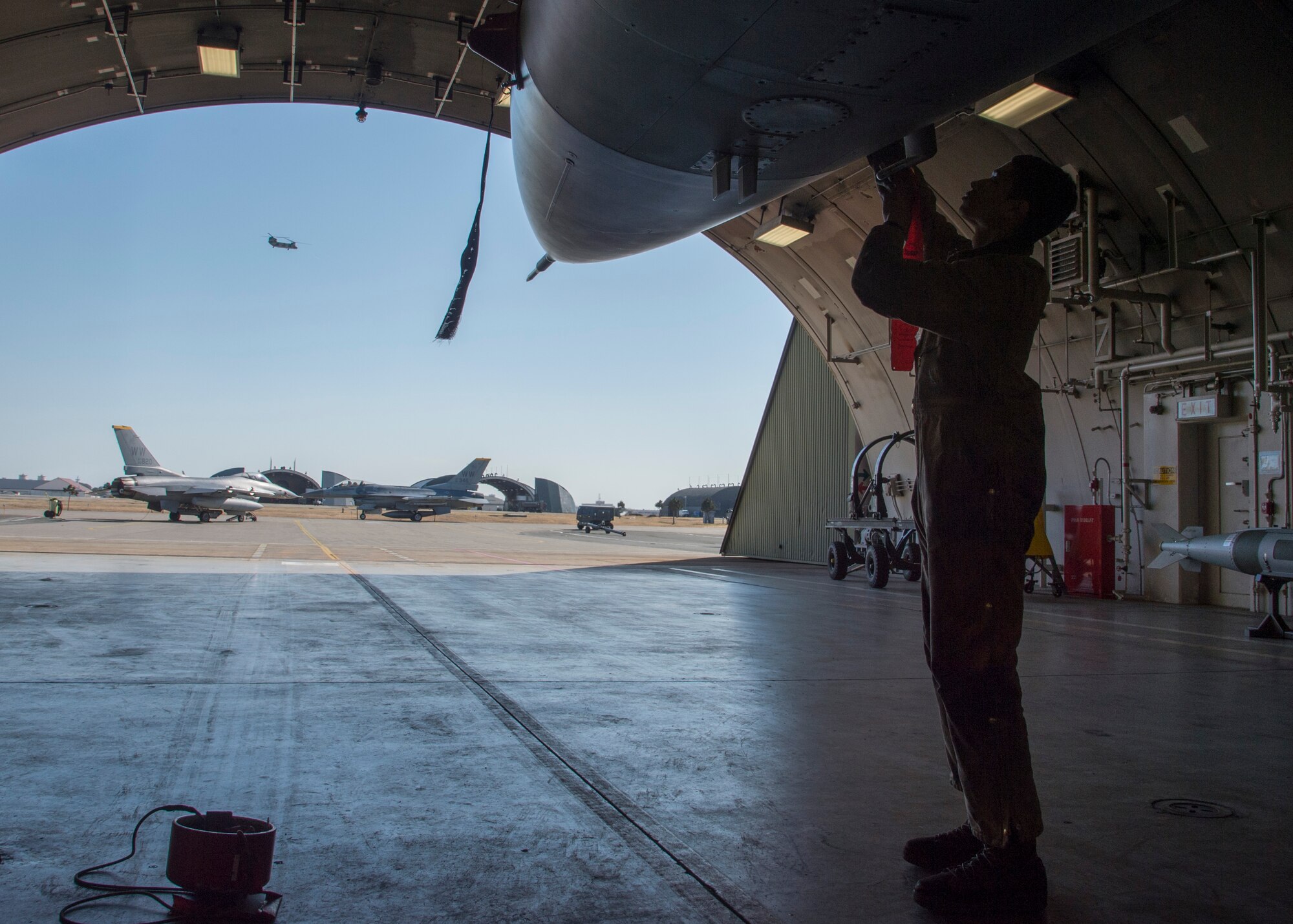 U.S. Air Force Senior Airman Kyle Lacy, a crew chief with the 35th Maintenance Squadron, places probe covers on an F-16 Fighting Falcon during a surge operation at Misawa Air Base, Japan, April 5, 2016. Crew chiefs perform post-flight inspections to ensure the F-16 remains capable of performing suppression of enemy air defense tactics. (U.S. Air Force photo/Airman 1st Class Jordyn Fetter/Released)