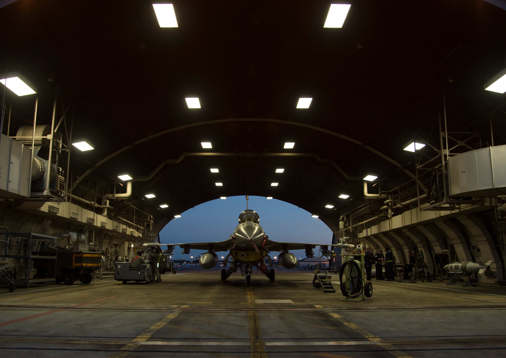 U.S. Air Force Airmen with the 35th Aircraft Maintenance Squadron arm an F-16 Fighting Falcon during a two-day surge exercise at Misawa Air Base, Japan, April 5, 2016. Along with standard maintenance to aircraft before and after flight, weapons load crew teams armed the aircraft to simulate a combat environment. During deployed operations, loading is essential for the F-16’s air-to-air combat and air-to-surface attacks. (U.S. Air Force photo/Airman 1st Class Jordyn Fetter/Released)