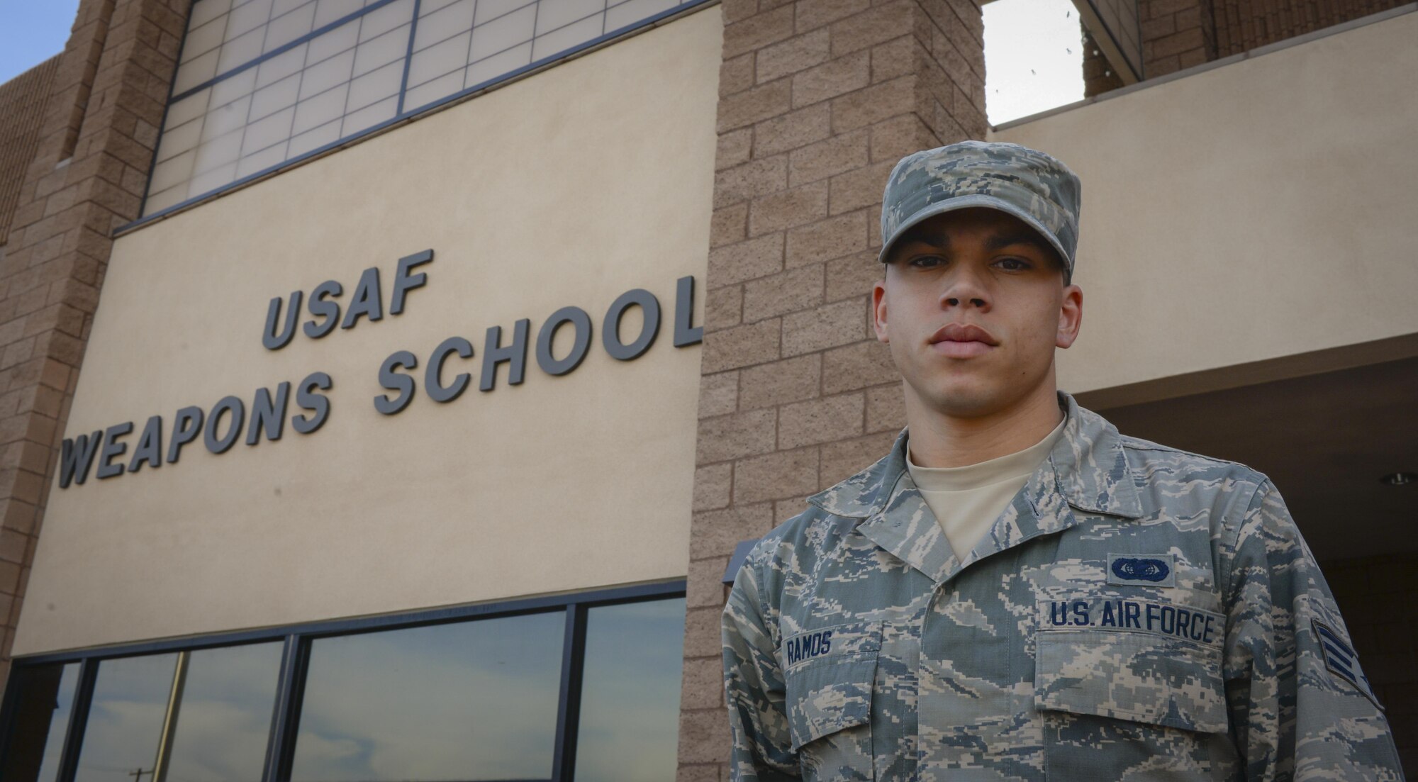 Senior Airman Edward Ramos, United States Air Force Weapons School command section administrator, poses in front of the USAFWS at Nellis Air Force Base, Nev., April 4, 2016. Ramos assisted four passengers who were in a car wreck on March 25, 2016.