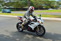 A Staff Sgt. from Joint Base Pearl Harbor-Hickam rides across the installation after receiving a motorcycle safety briefing during Motorcycle Safety Day on Joint Base Pearl Harbor-Hickam, April 1, 2016. Approximately 175 motorcycle riders from JBPHH met up at the Hickam Memorial  Theater to talk about motorcycle safety as well as share personal stories and experiences pertaining to riding. The motorcycle safety event fulfilled an Air Force annual requirement for motorcycle riders. (U.S. Air Force photo by Tech. Sgt. Aaron Oelrich/released) 