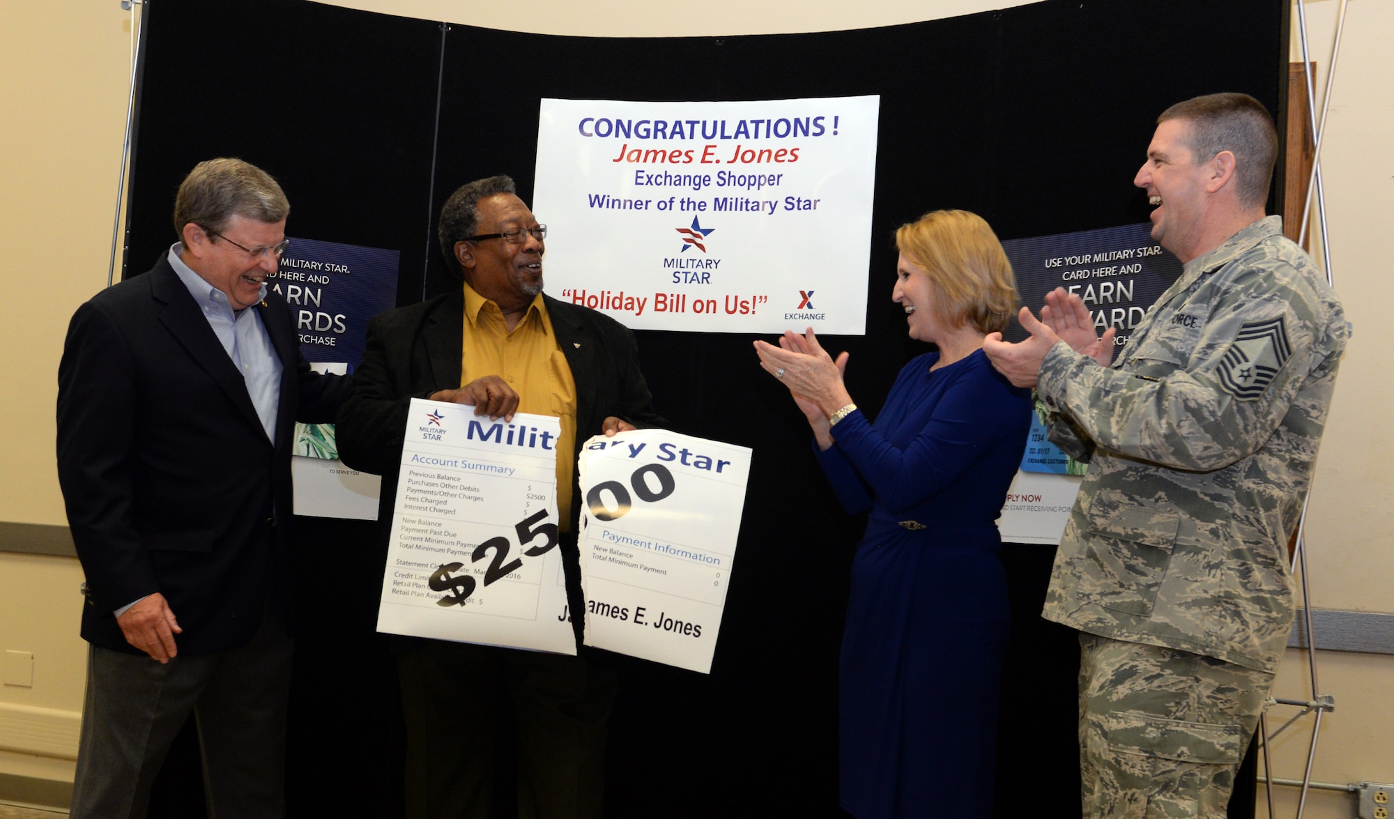 Community and Exchange leadership honor retired Air Force Chief Master Sgt. James Jones at Barksdale Air Force Base, La., March 31, 2016. Jones is a Vietnam War veteran and Shreveport resident who won a grand prize in Military Star’s Your Holiday Bill Is On Us sweepstakes. Jones had his account balance paid in full and will receive additional store credit. (U.S. Air Force photo/Airman 1st Class Curt Beach)
