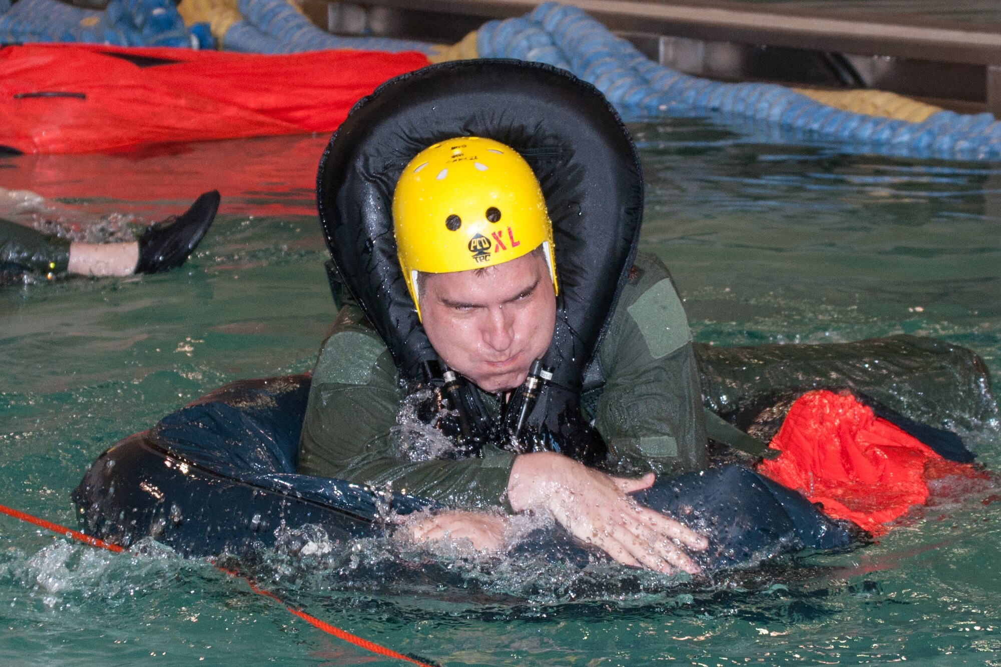 U.S. Air Force Maj. Jesse Hildebrand, assigned to the 93rd Bomb Squadron, struggles to enter a life raft during water survival training held in the pool at Louisiana State University, Shreveport, La. on April 3, 2016. Participants of the training are coached by Reservists from the 307th Operations Support Squadron on various survival techniques in the event of a water-based landing or ejection. (U.S. Air Force photo by Master Sgt. Dachelle Melville/Released)