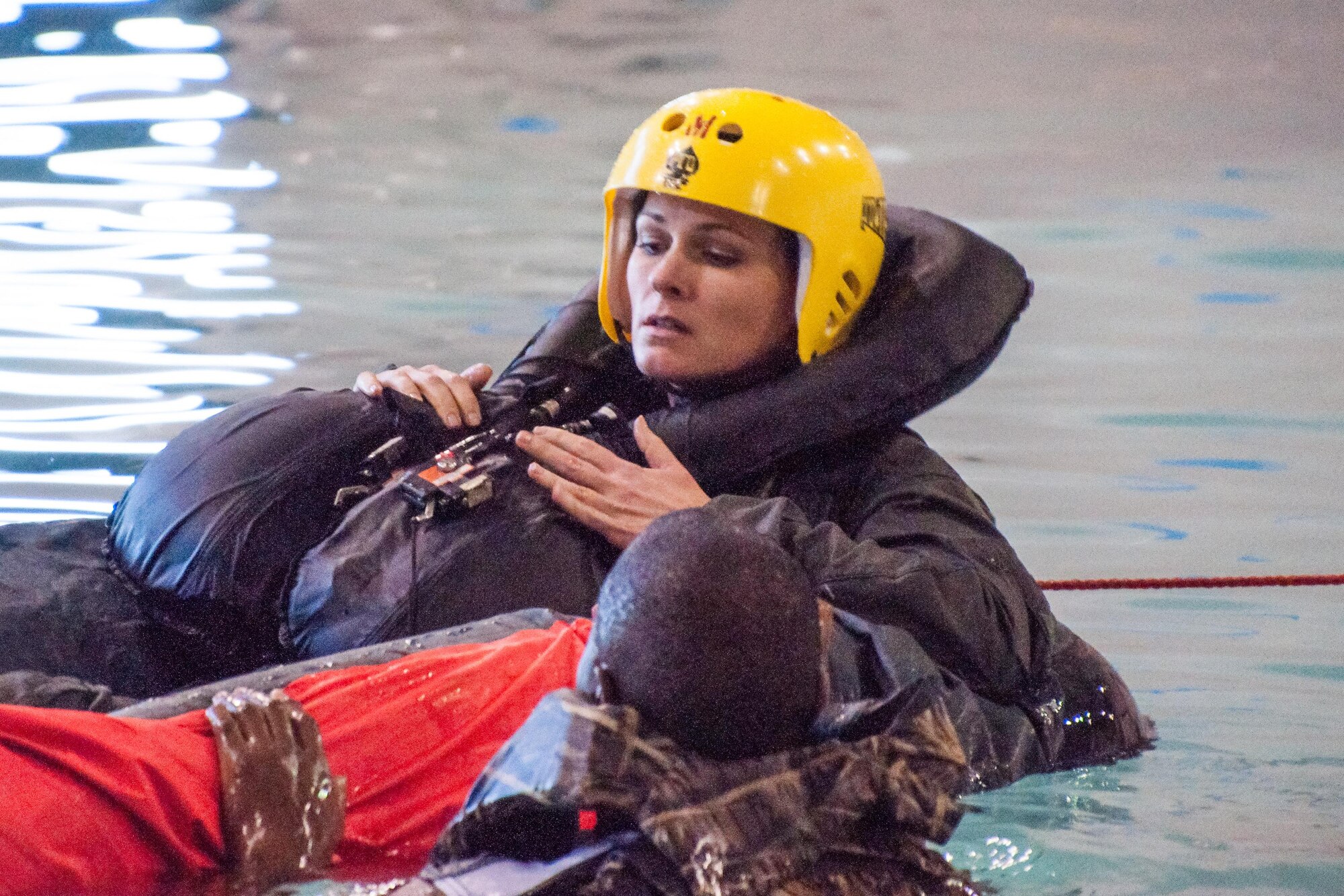 U.S. Air Force Maj. Heather Decker, assigned to the 93rd Bomb Squadron, is trained on water survival procedures in a life raft in a pool at Louisiana State University, Shreveport, La. on April2, 2016. Water survival training helps aircrew members practice what to do in the event of a waterborne landing. (U.S. Air Force photos by Master Sgt. Dachelle Melville/Released)